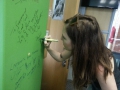 Josie signing East Coast Radio wall